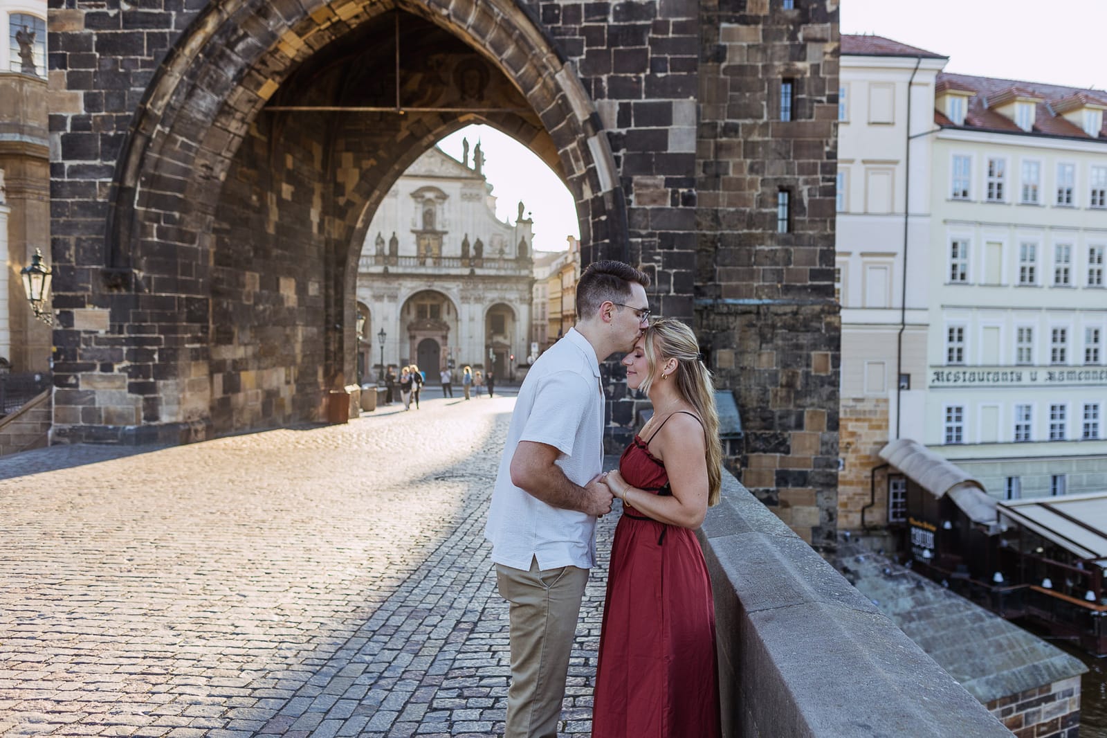 Couple beneath the Old Town bridge tower on Charles Bridge